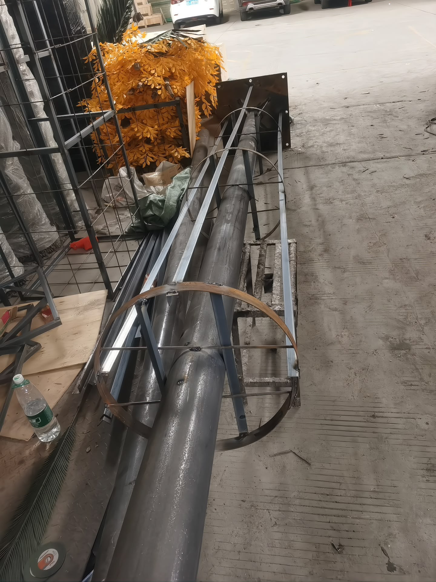 Trunk core welded in-house: steel tube, brace rings and base plate