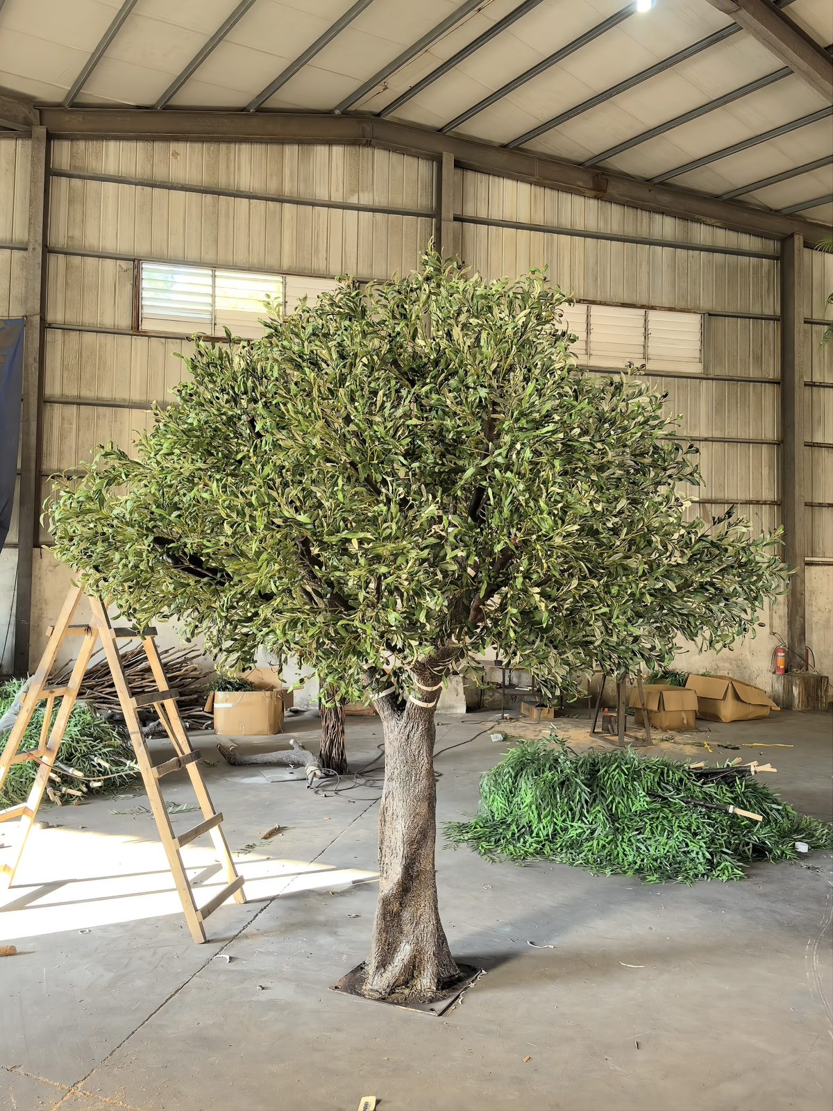 Artificial olive tree with round canopy under construction in the workshop