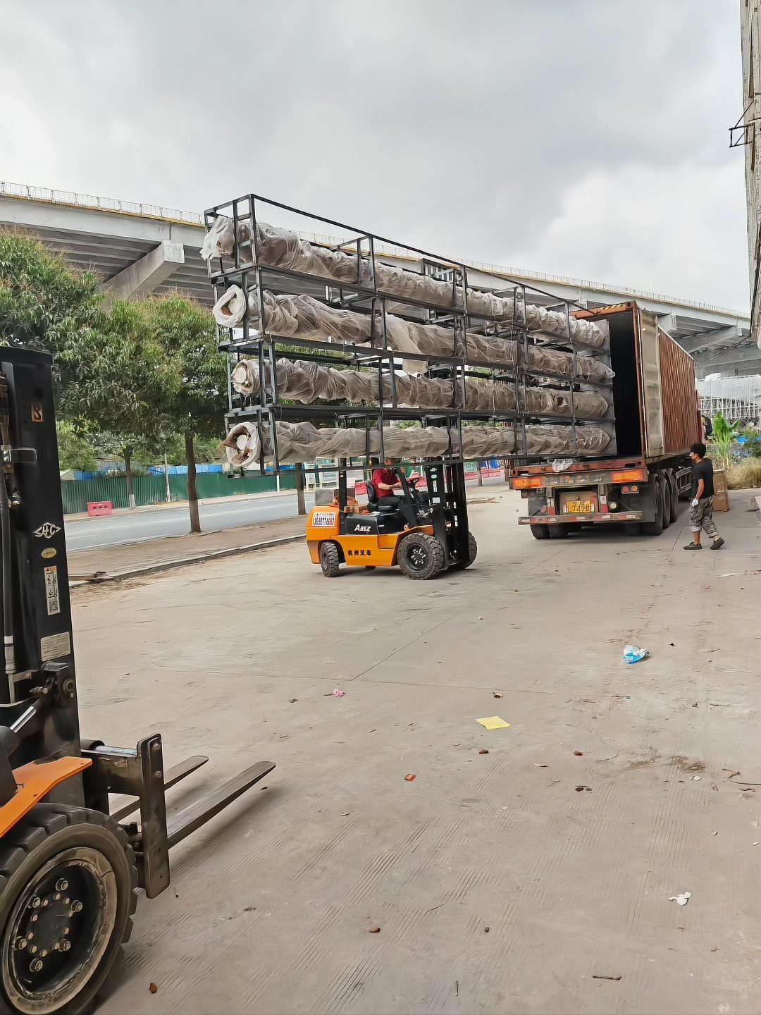 Welded steel racks lifted onto the truck by forklift