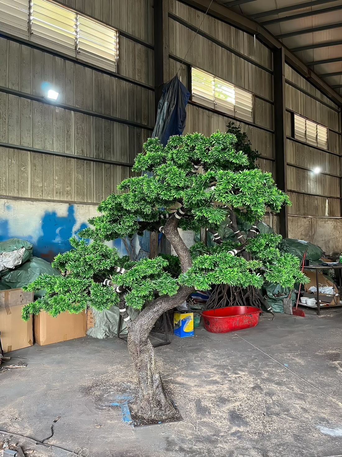 Sculpted pine in the workshop — branch layers set to the approved drawing