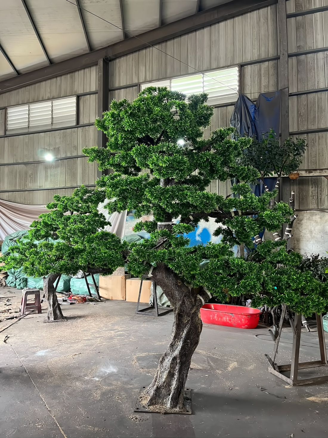 A matched pair of sculpted pines, produced as one set for a single project
