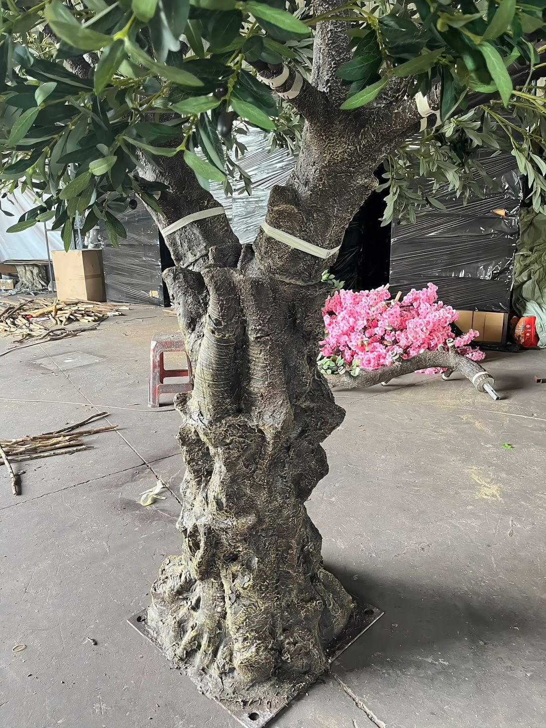 Trunk base detail — fibreglass root flare moulded over a bolted steel base plate