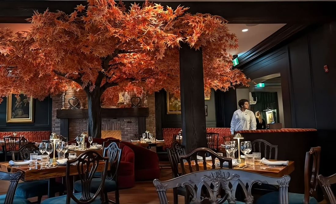 Artificial autumn maple tree installed over the dining area of a restaurant