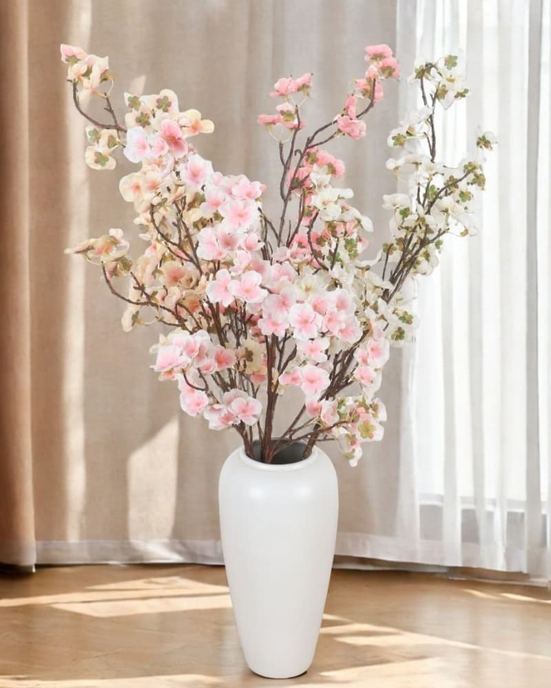 Artificial cherry blossom arrangement in a vase, a low-maintenance flowering display for commercial interiors