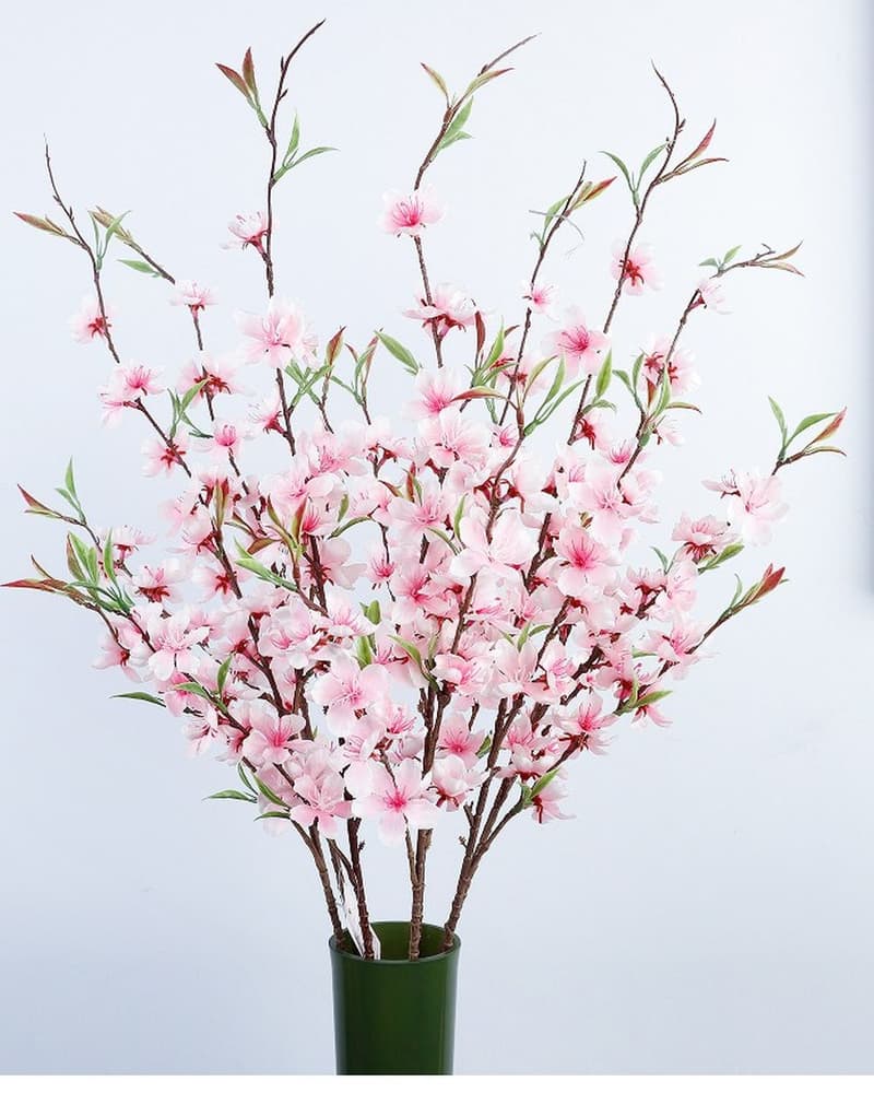 An artificial flowering branch from the floral range, built on a reinforced stem like the orchid arrangements