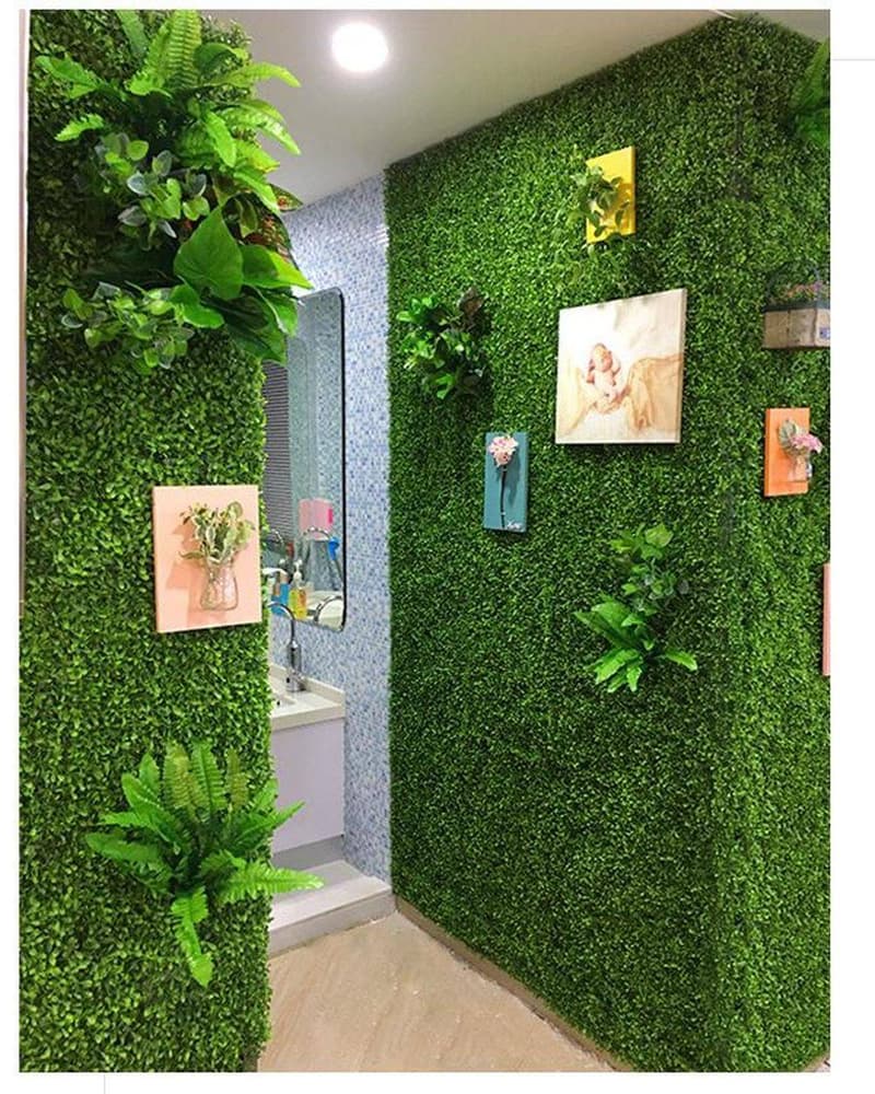 Boxwood artificial green wall lining a clinic corridor with framed picture ledges