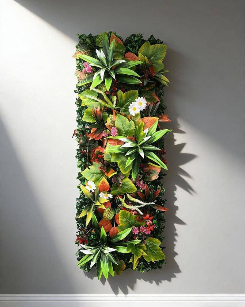 Mixed foliage artificial green wall panels installed on a plain grey interior wall