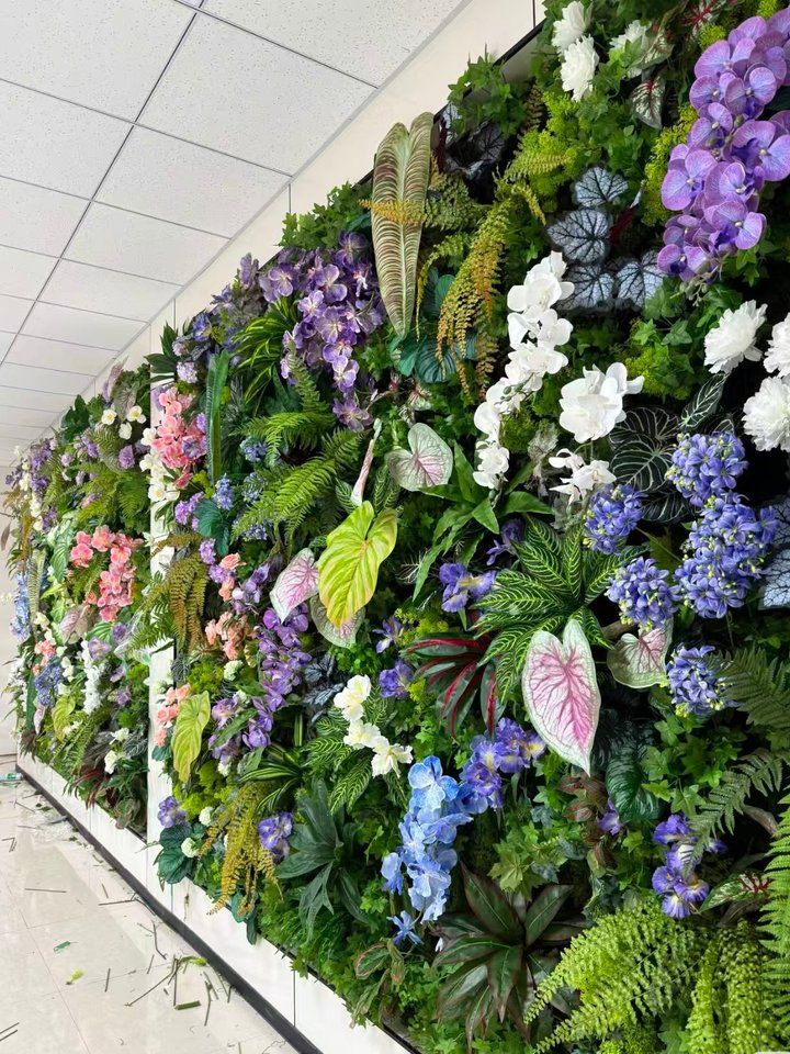Full-height indoor engineered green wall with mixed florals, project photo