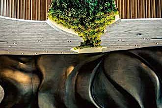 Artificial green wall and tree scheme in a hotel lobby