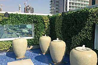 Artificial planters installed poolside at a resort