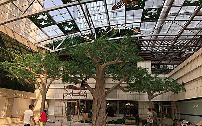 Artificial tree installation in a hotel lobby interior